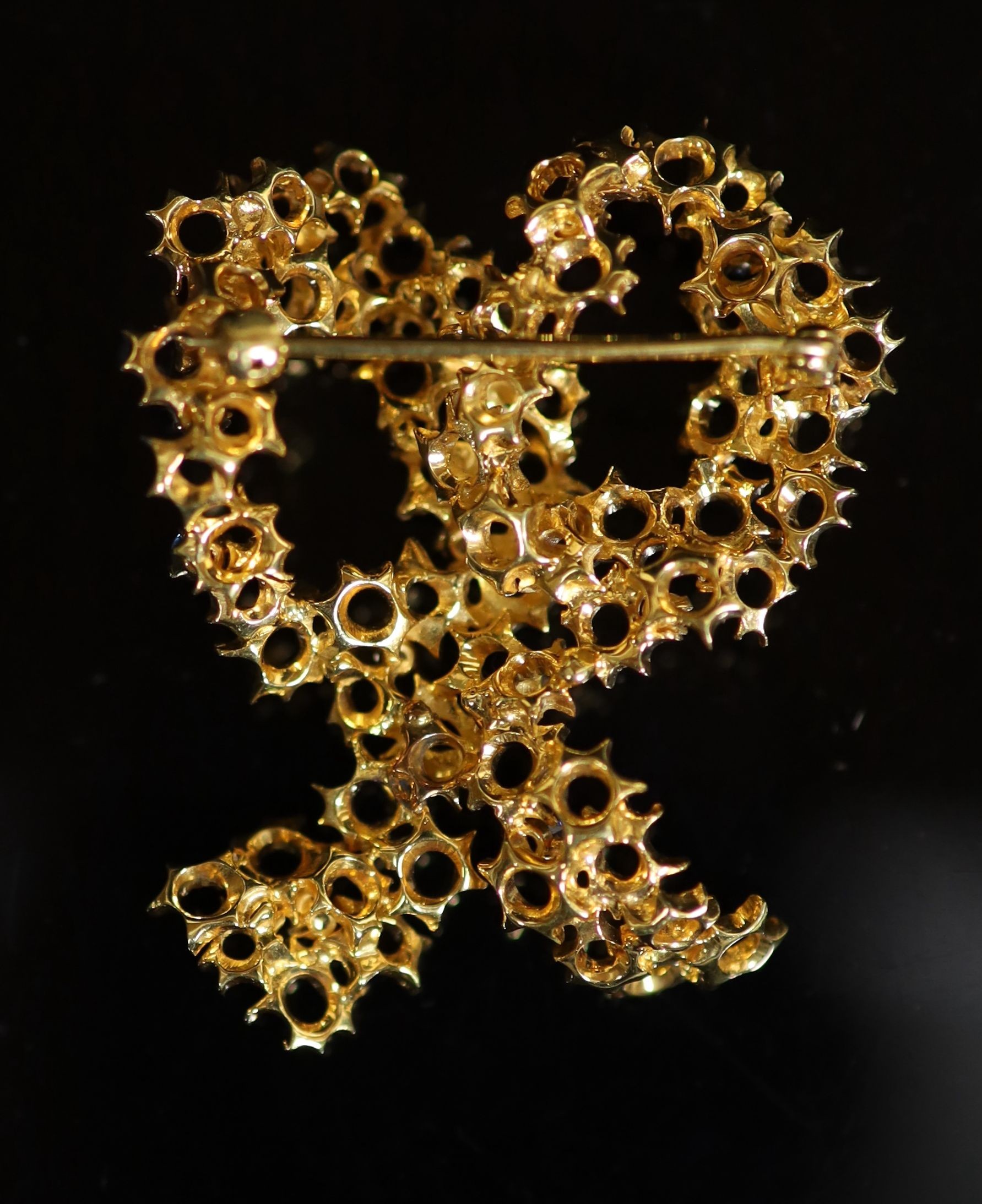 A 1970's? textured gold, seven stone sapphire and seven stone diamond set double loop brooch